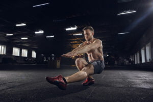 young man doing pistol squat